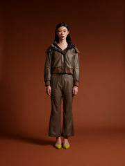 model wear brown bomber jacket with vegan leather trousers