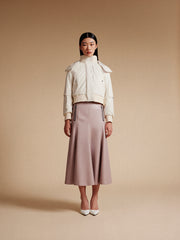 model wear white bomer jacket and pink long skirt
