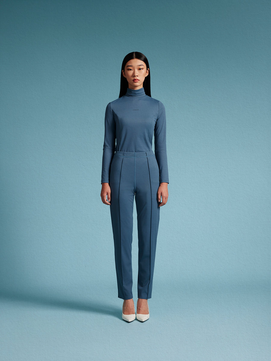 model wear blue turtle neck top and blue pants