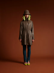 model waear kaki coat with vegan leather hat