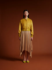 Model wear Yellow jacket and gold skirt