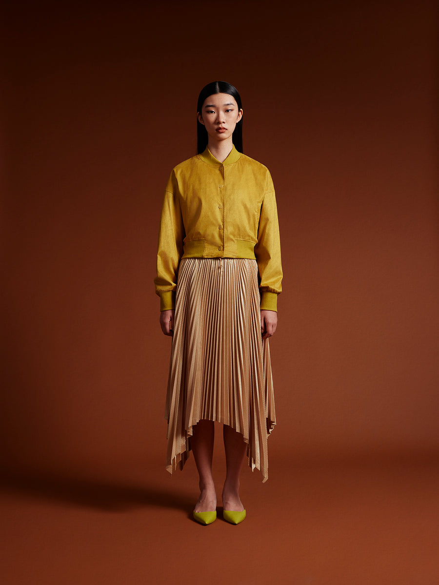 Model wear Yellow jacket and gold skirt