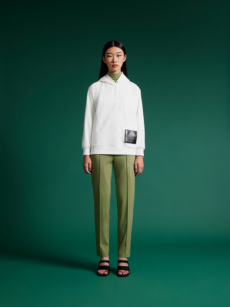 model wear white hoodie with green trousers
